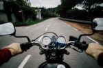 How A Motorcycle Accident Lawyer Can Help You - Motorcycle handlebar POV on road highway