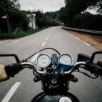 How A Motorcycle Accident Lawyer Can Help You - Motorcycle handlebar POV on road highway