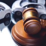 Sharing Information After An Accident - Model of car and gavel. Accident lawsuit or insurance, court case